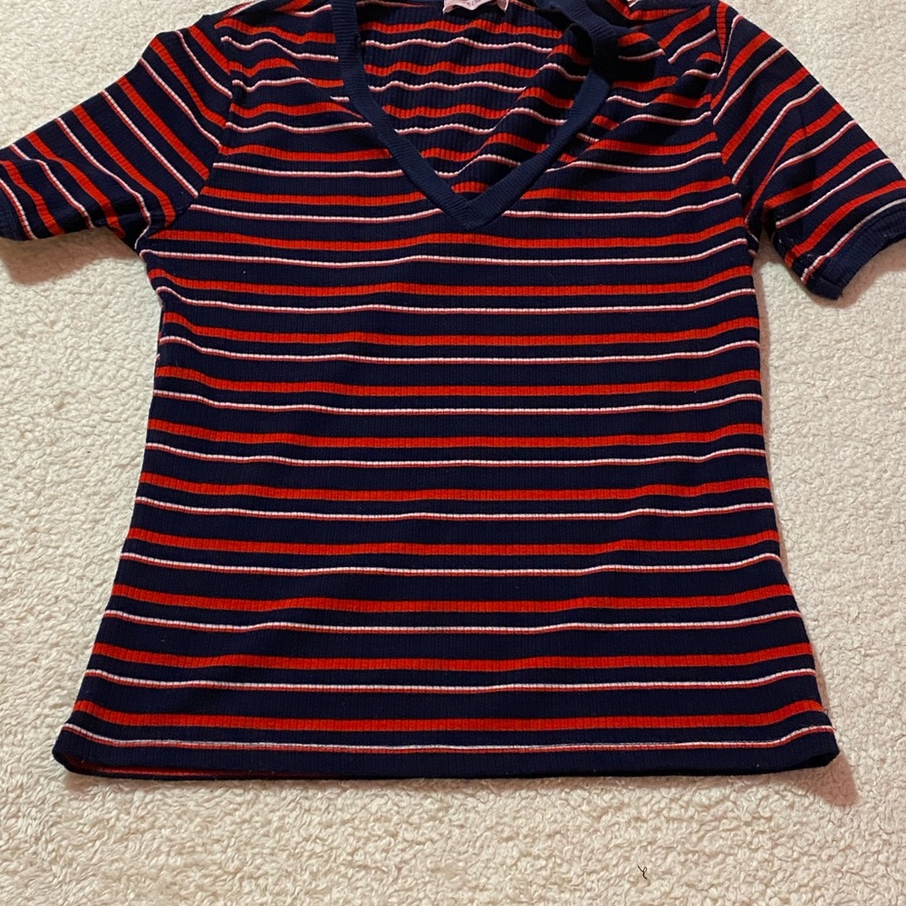 White and red and blue v neck shirt